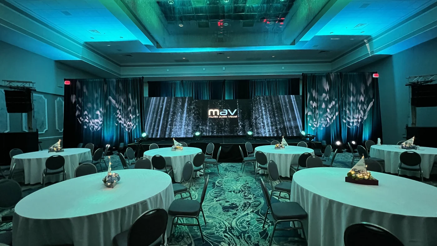 Hotel ballroom with MAV LED video wall and teal uplighting